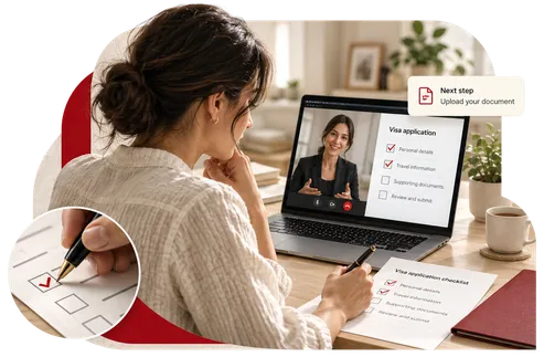 An applicant completing a visa checklist at her desk during a video call with an adviser